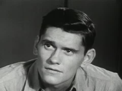 Close-up of a young man listening intently during a conversation.