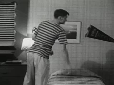 The teenager takes off his robe and gets into bed to sleep.