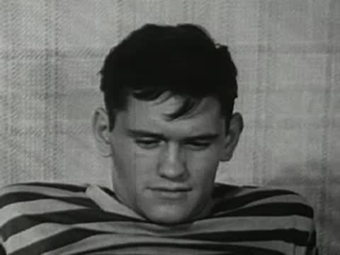 Close-up of the teenager resting his head on the pillow in bed.