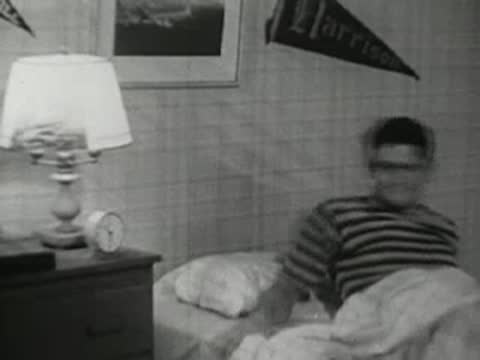 The teenager lies in bed awake, then reaches out to turn off the lamp.