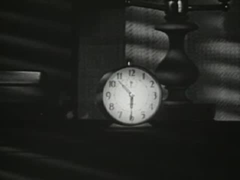 A clock on a nightstand as the room darkens or lights turn off.