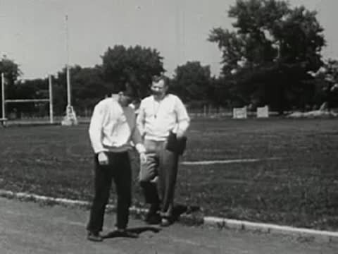 Coach walking and talking with a runner after the workout.