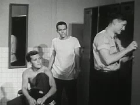Teenage boys get dressed in a vintage school locker room.