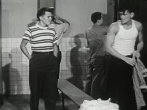 Boys changing clothes in the locker room after practice.