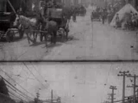 Horse carriage and tents line the dusty street during the post-disaster period.