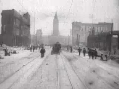 Distant horse-drawn carriage and pedestrians on a wide ruined city street.