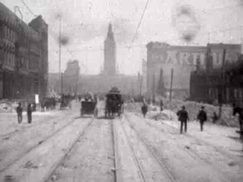Horse-drawn carriage and pedestrians moving down a ruined avenue.