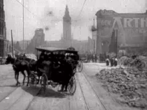 Close-up of a horse-drawn carriage passing by on a ruined city street.
