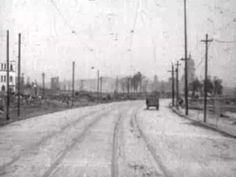 Wide road heading toward a distant domed building amidst sparse surroundings.