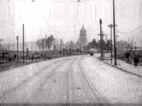 Street view curving toward a prominent domed building in the distance.
