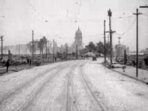 Road leading toward a distant dome with sparse trees and open space.