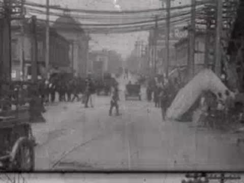 Busy street with horses and makeshift shelters after the disaster.