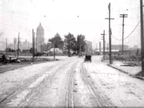 Road stretching toward a distant city skyline and domed building.