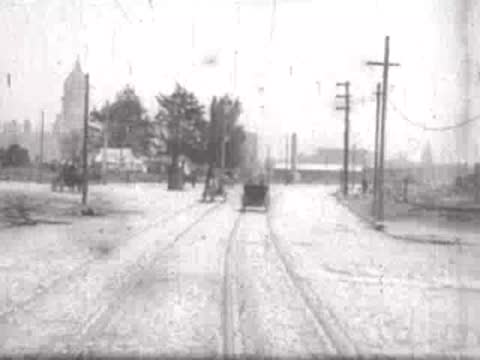 Road leading toward a distant cityscape with a prominent dome.