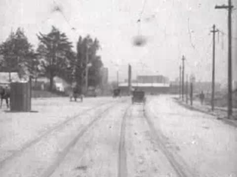 Looking forward from a moving tram down a San Francisco street, historical footage.