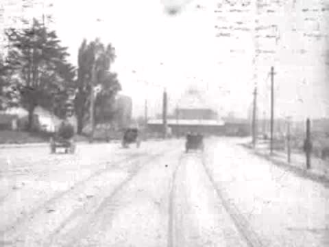 Looking forward from a moving tram down a San Francisco street, historical footage.