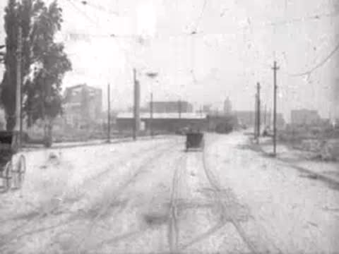 Looking forward from a moving tram down a San Francisco street, historical footage.