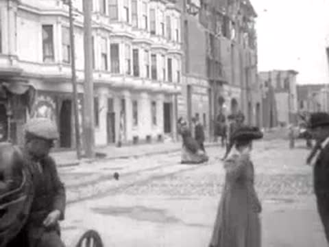 people walking along damaged street in San Francisco, historical footage