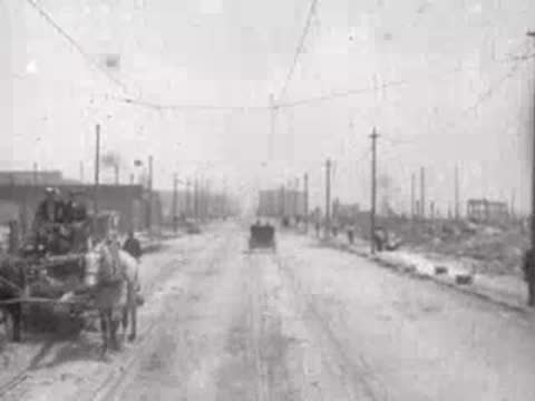 damaged street with horse-drawn carriage moving away, historical footage
