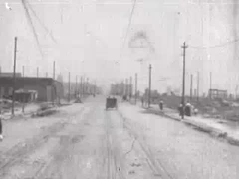distant horse-drawn carriage on damaged road, historical footage