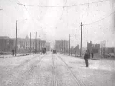 pedestrian standing near wide ruined street, historical footage
