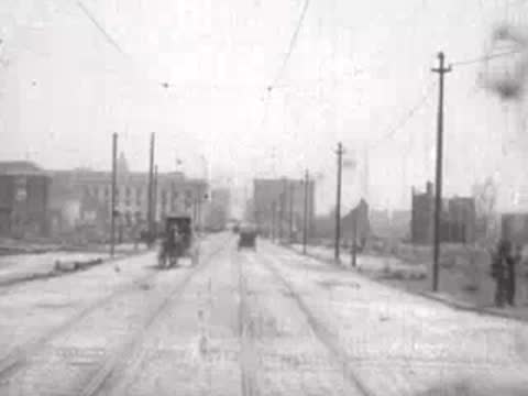 horse-drawn carriage approaching on wide damaged street, historical footage