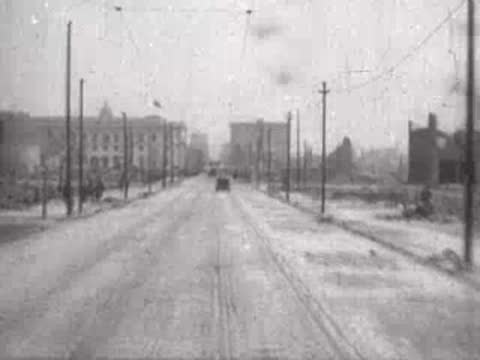 wide street with distant carriage and ruined buildings, historical footage