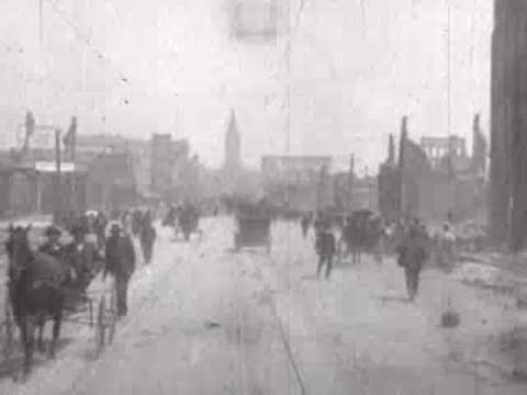 Street view after San Francisco earthquake, horse-drawn cart, pedestrians, rubble.