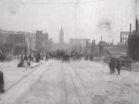 Street view after San Francisco earthquake, pedestrians, horse-drawn carts, rubble.