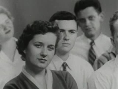 Group of people looking attentively, 1950s educational film