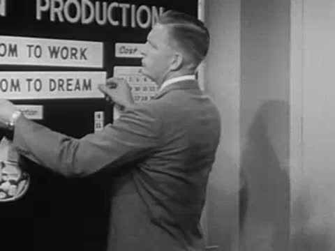 Man attaches a label reading Freedom to Work on a board