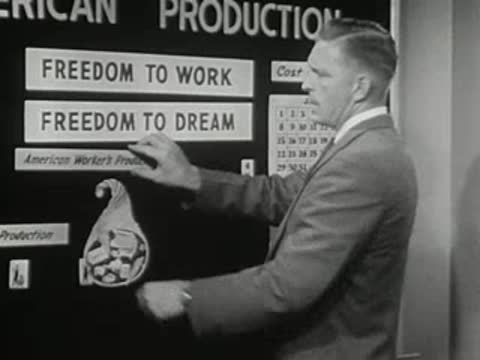 Man places label reading Freedom to Dream on a board