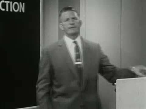 Man stepping away from a chart board, 1950s educational film