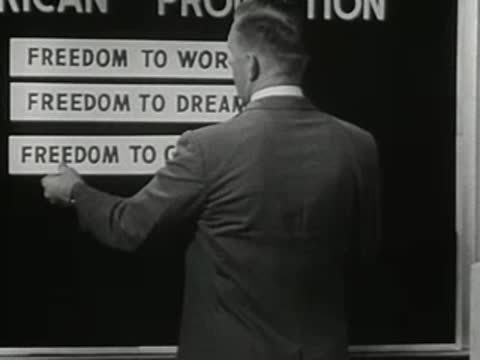 Man places a Freedom to Compete label on a chart board