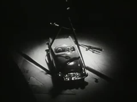 studio spotlight illuminating a classic convertible car from above