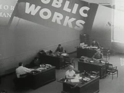 high-angle view of office workspace with superimposed public works text graphic