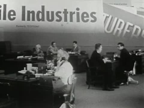 wide office scene with multiple employees at desks and superimposed industry magazine titles