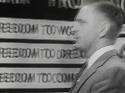 A speaker places cards on a display board listing freedoms like work and compete.
