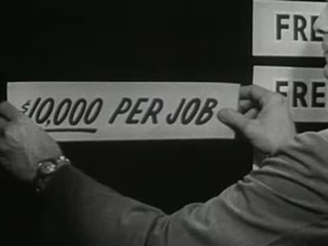 Hands position a sign reading ten thousand dollars per job on a display board.