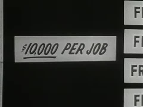 A sign reading ten thousand dollars per job is adjusted on a display board.