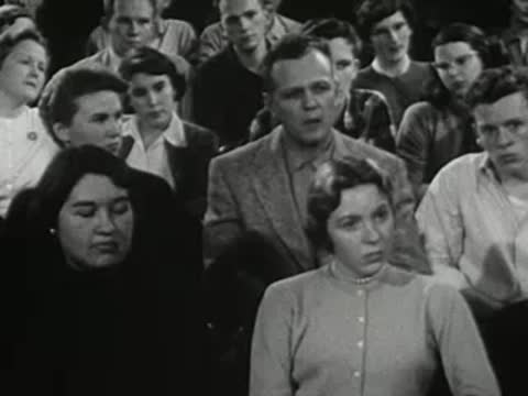Audience of students seated and looking forward in a lecture hall