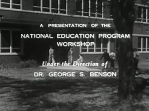 Text credits overlay a shot of people walking toward a brick building.