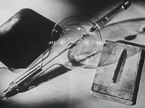 Close-up of a large glass X-ray tube and photographic plate.