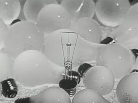 Static view of glowing glass lightbulbs and filaments in laboratory.