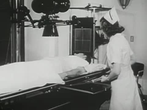 Nurse prepares a patient on a medical examination table beneath X-ray equipment.