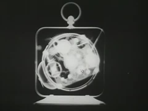 X-ray view of the internal mechanism of a ticking clock.