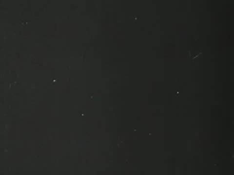 Title card fades to black with faint glowing light speckles visible.