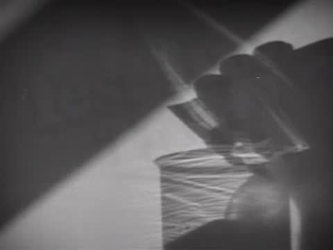 Title sequence with a hand pouring liquid, 1940s scientific theme