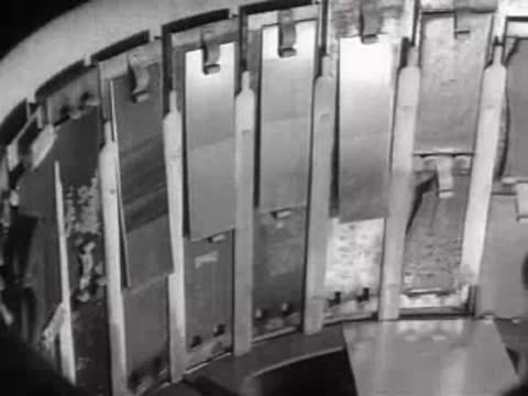 Close-up view of test panels mounted inside a rotating weathering test chamber.