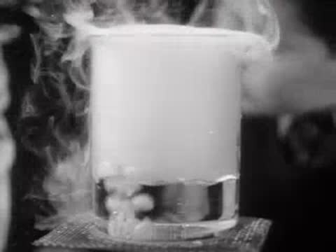 Vapor rising from a chemical beaker on a stand, laboratory scene